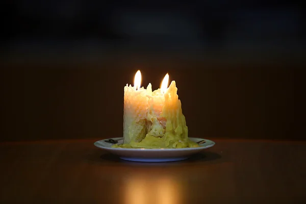 Burning candle over black background — Stock Photo, Image