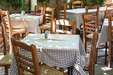 empty terrace cafe with wooden chairs and tables 