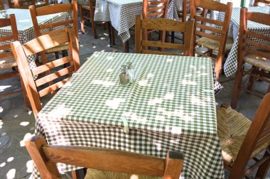 empty terrace cafe with wooden chairs and tables 