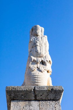 ancient stone statue against blue sky 