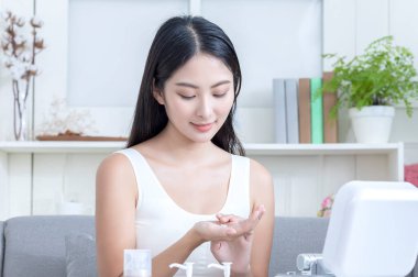 attractive asian girl with skin cream, beauty concept 