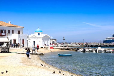 people on beach of Greece town on sunny day