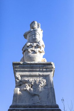 ancient stone statue against blue sky 