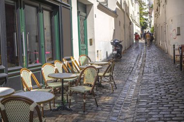 empty terrace cafe with wooden chairs and tables 