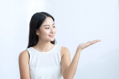 joyful asian girl gesturing by hand, advertise concept