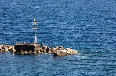 aerial shot of small lighthouse in ocean