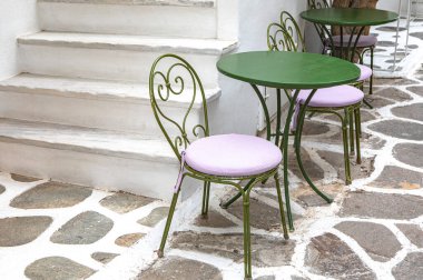 empty tables with chairs, street cafe