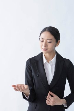 attractive asian businesswoman gesturing by hands
