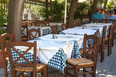 empty terrace cafe with wooden chairs and tables 
