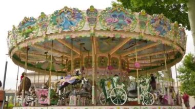 French style rotating carousel in Carcassonne. Amusement park for children. Fairground in France. Big recreation funfair for kids leisure time.