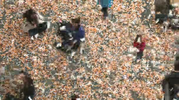 Multicolored Confetti Falling on Children Time Lapse.  Celebration party with lots of confetti, children and families. Confetti cannon confetti expelling everywhere. Children's workshops games. Children and family games. — Stock Video