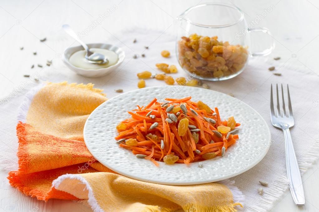 Carrot salad with raisins, sunflower seeds and honey