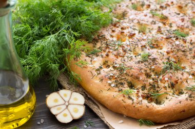 Homemade focaccia with dill, garlic and olive oil clipart
