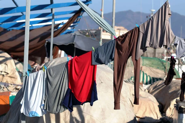 photograph of sailors clothes hanging in the harbor,