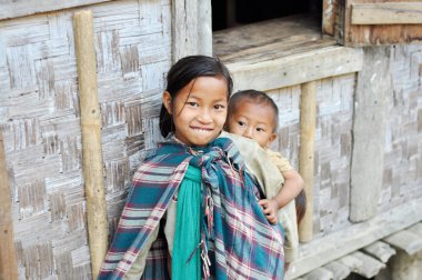 Smiling older sister carrying kids in Nagaland, India