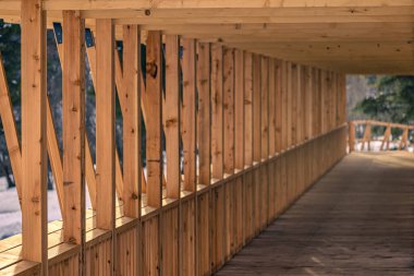 Buzul nehrinin karşısındaki ahşap yapı. Katı meşeden yapılmış modern bir köprü. Doğal mimari orman kütüklerini engelliyor.