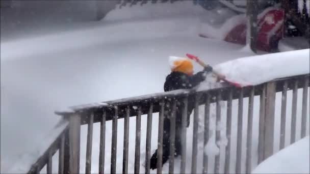 Child Shovels Porch Snow — Stock Video