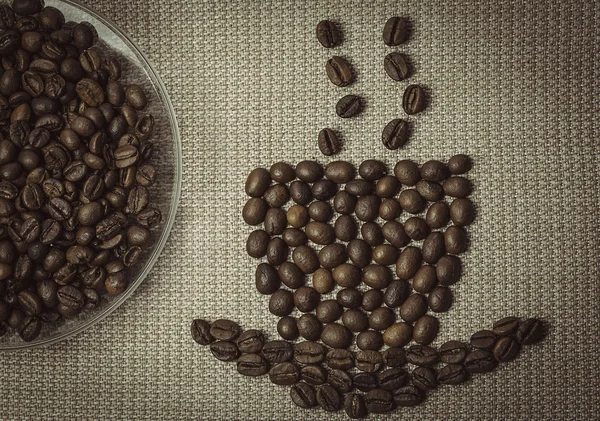 Coffee aroma concept. Coffee cup made from beans and plate with — Stock Photo, Image