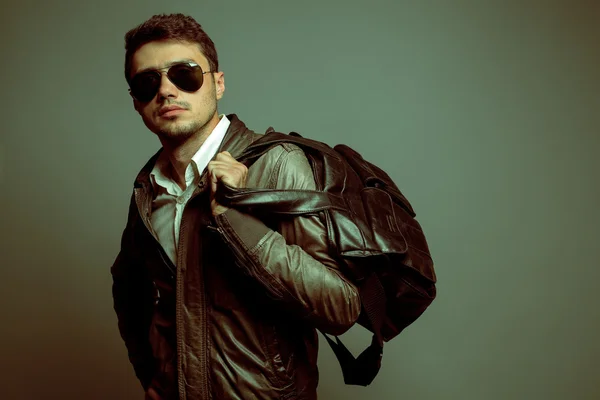 Fashion portrait of young handsome man model in leather jacket h