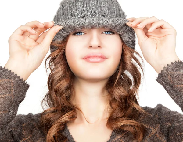 Pretty young woman with beautiful blue eyes smiling  in grey hat Stock Picture