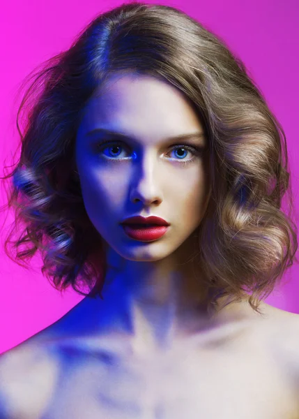 Glamour beautiful woman with perfect professional make up over magic blue and pink litening. — Stock Photo, Image