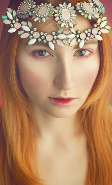 Tender portrait of beautiful red haired (ginger) woman with jewelry in her hairs.