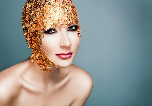 Close-up modelo da menina retrato em uma folha de ouro elegante . — Fotografia de Stock