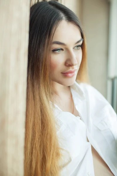 Emotive portrait of beautiful woman with long hair in white shir — Stock Photo, Image