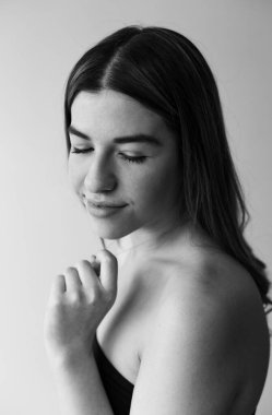 Bir güzelin siyah beyaz portresi. Siyah bir kazak giyiyor.