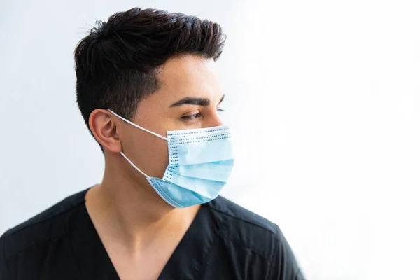 Close-up of a doctor with mask and glasses. White background