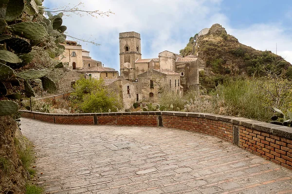 street in Savoca in Sicily used by Frances Ford Coppola for scenes in the film the Godfather.The site of the old town is about 300 m above the sea, while a very steep and almost isolated rock, crowned by a Saracen castle, rises about 150 m higher: