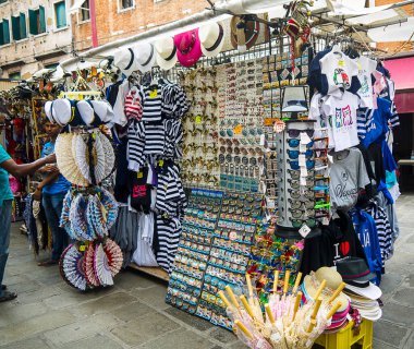 Street souvenir stall on the quayside in Venice Italy catering to the tourist trade clipart