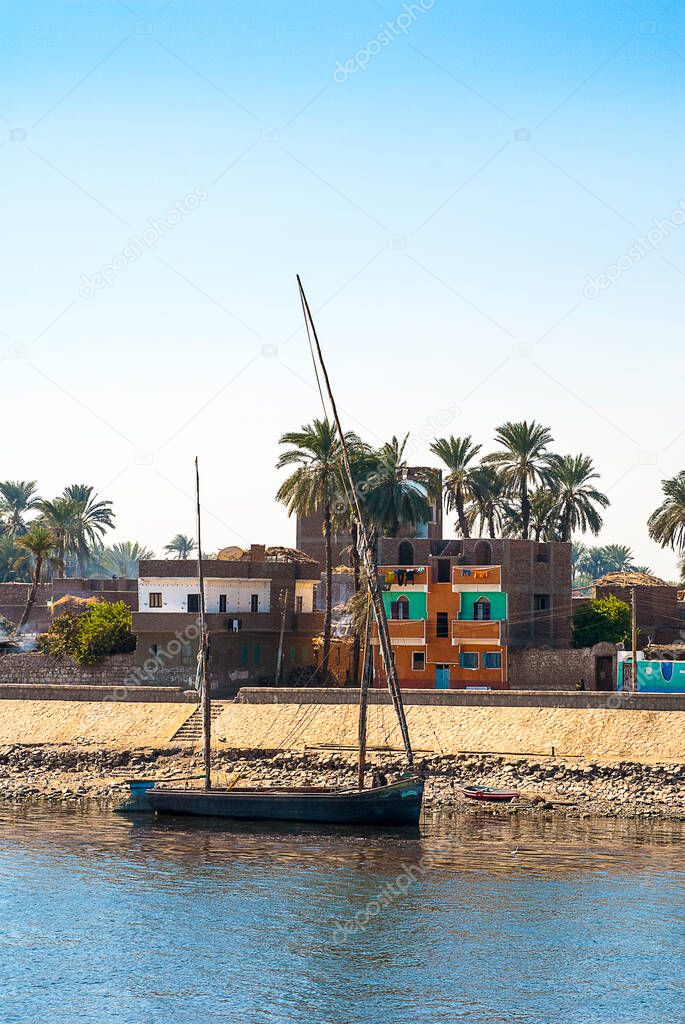 Feluccas are the traditional sailing ships that trade on the River Nile.The boats criss-cross the River taking people and goods from one side to the other.Their white sails are outlined against the blue of the Egyptian sky or moored with folded sails