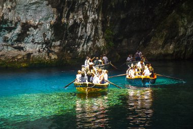 On the island of Kephalonia, Melissani Lake was the Cave of the Nymphs. It is a lake surrounded with trees and forest.It is a kind of cenote (pronounced sea note ee)The lake's bottom is covered with stones from the collapsed roof of the cave long ago clipart