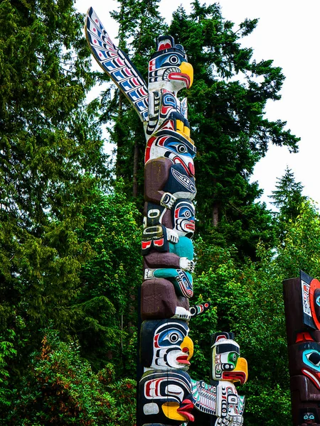 Totem Poles in Stanley Park in Vancouver British Columbia, Canada.Totem poles are monumental sculptures carved from large trees, usually Western Red Cedar, by cultures of the Indigenous peoples of the Pacific Northwest Coast of North America