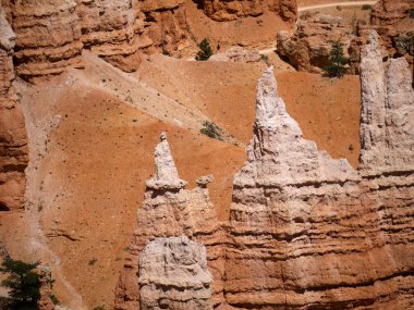 BryceCanyon is distinctive due to its geological structures, called hoodoos, formed from wind, water, and ice erosion of the river and lakebed sedimentary rocks these are eerie and often whimsical clipart