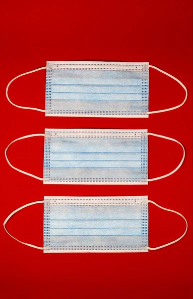 Prevent infections. Medical masks, Medical protective masks isolated on red background. Disposable surgical face masks cover mouth and nose. Healthcare medical Coronavirus quarantine, hygiene concept