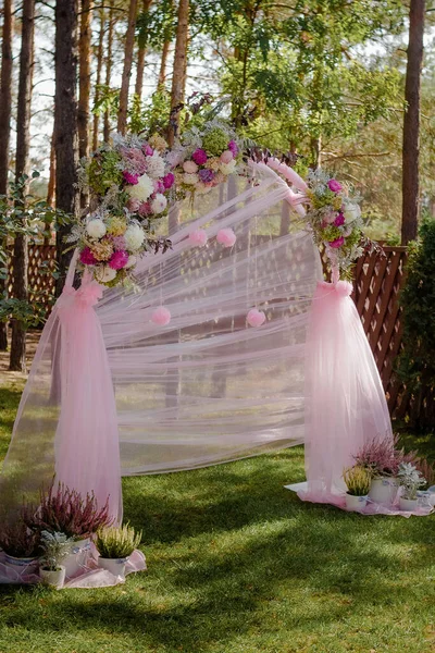 Arco de boda con flores dispuestas en el parque para una ceremonia de boda — Foto de Stock