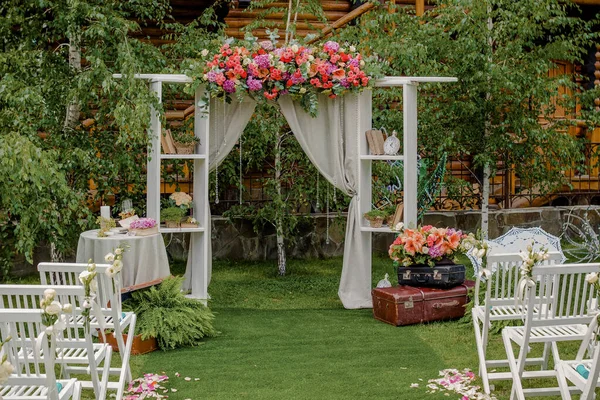 Wedding arch made of cloth and white and pink flowers on a green natural background. Old doors, rustic style — Stock Photo, Image