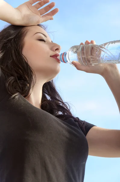 Flicka dricker vatten från en flaska efter träningen — Stockfoto