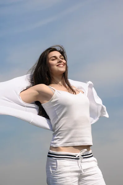 Menina respira ar fresco em um fundo azul céu . — Fotografia de Stock