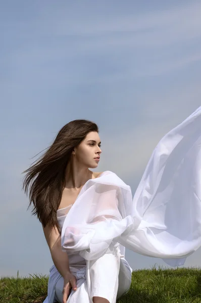 Chica sostiene la tela en las manos saludando en el viento —  Fotos de Stock
