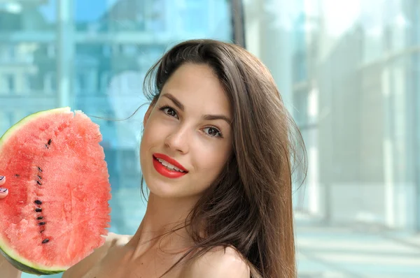 Girl is holding a slice of watermelon — Stock Photo, Image