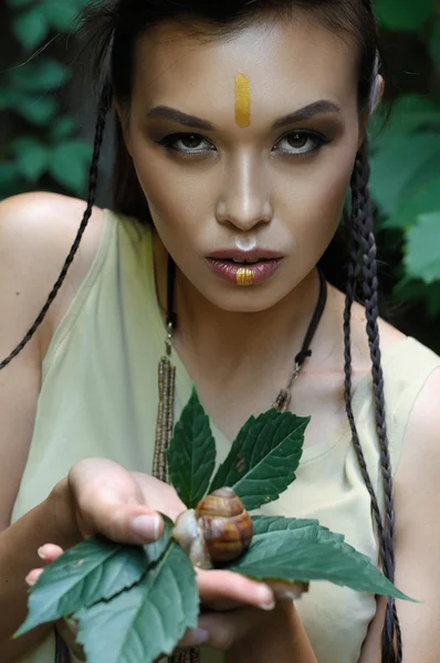 Girl holding a snail in her hands. — Stock Photo, Image