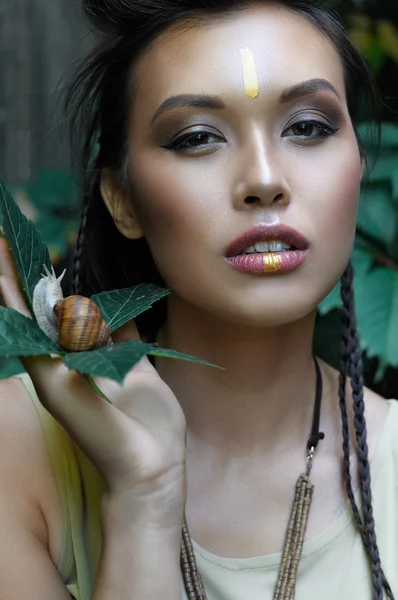 Girl holding a snail in her hands. — Stock Photo, Image