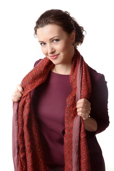 Woman in a burgundy dress which holds in his hands a scarf — Stock Photo, Image