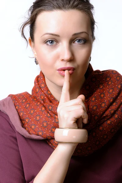 Woman put her finger to her lips — Stock Photo, Image