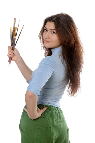 Artist holding brushes in her hand turned to the camera — Stock Photo, Image