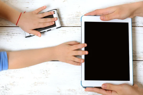 Mother and child holding a tablet and a phone — Stock Photo, Image