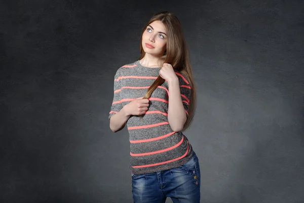 Girl looking up caring for her hair a — Stock Photo, Image